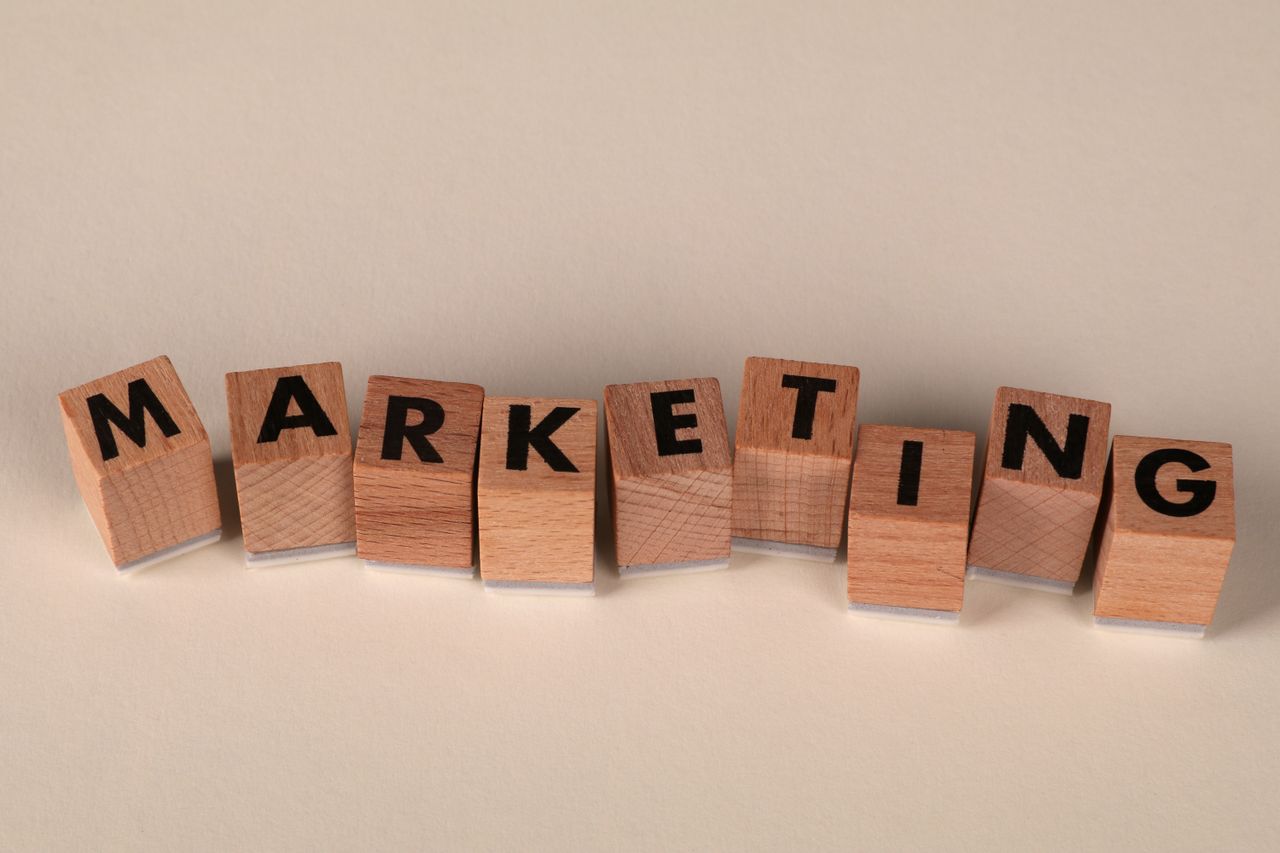 Wooden blocks with letters spelling marketing, ideal for business and advertising visuals.